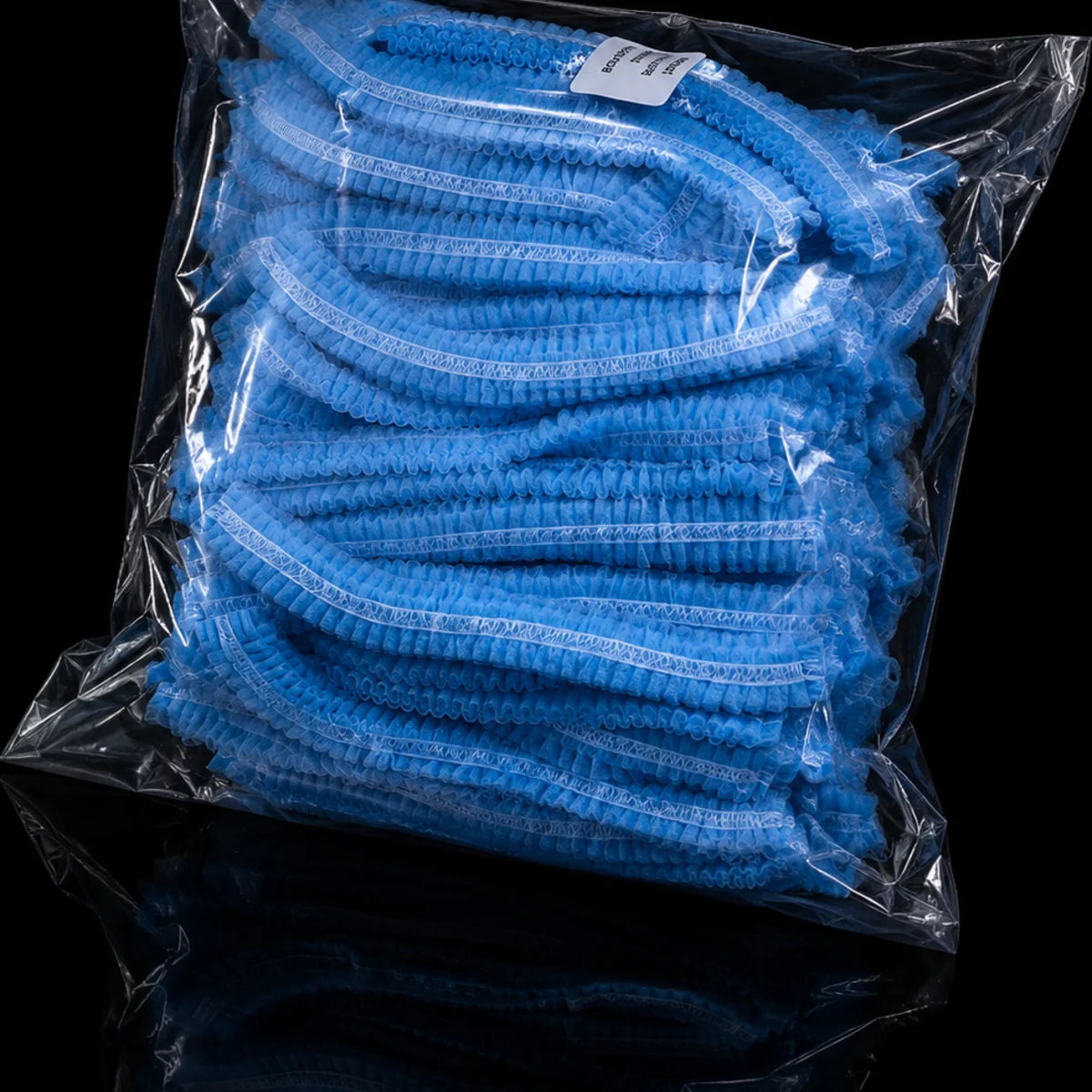 Packed blue disposable head caps