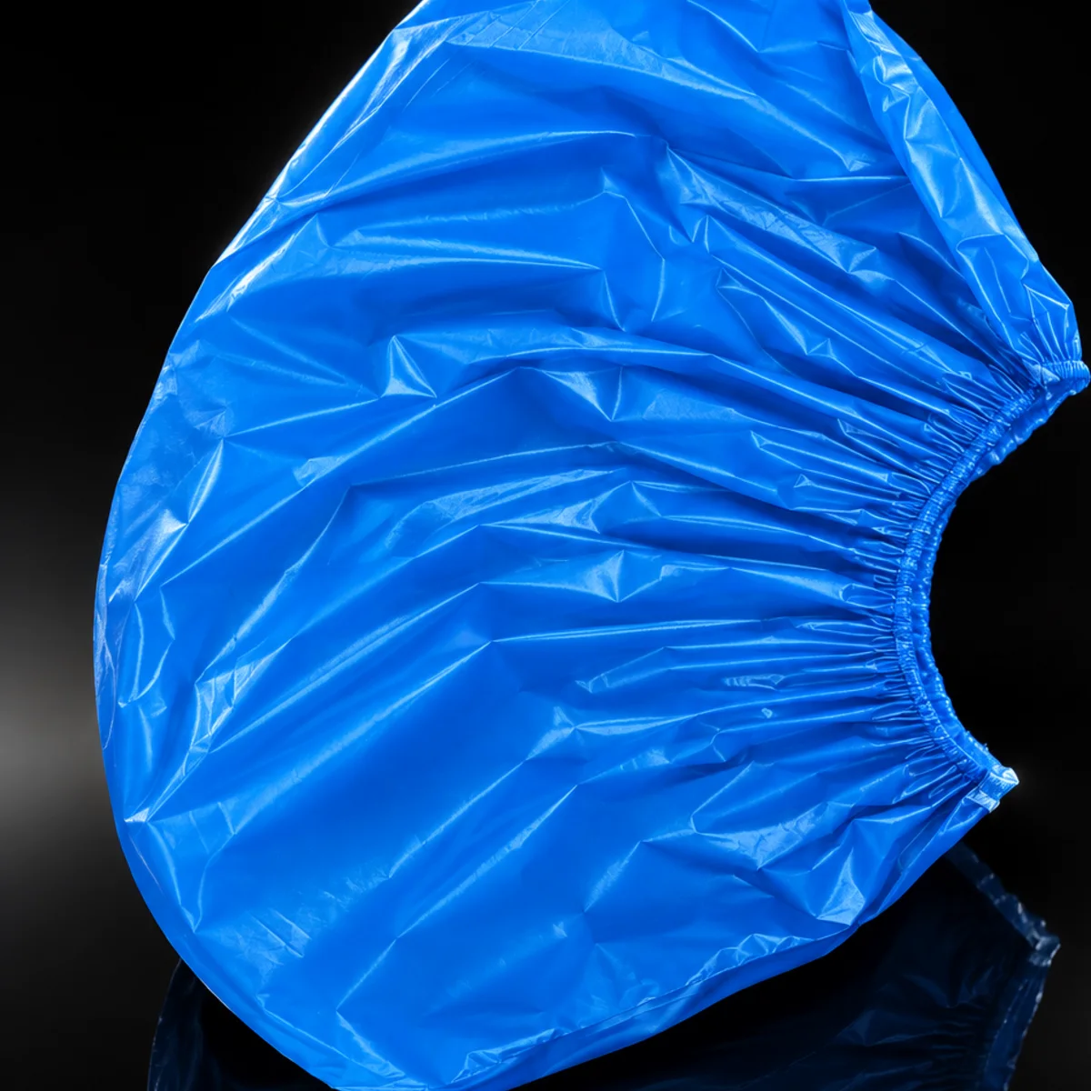 Blue disposable shoe cover close-up